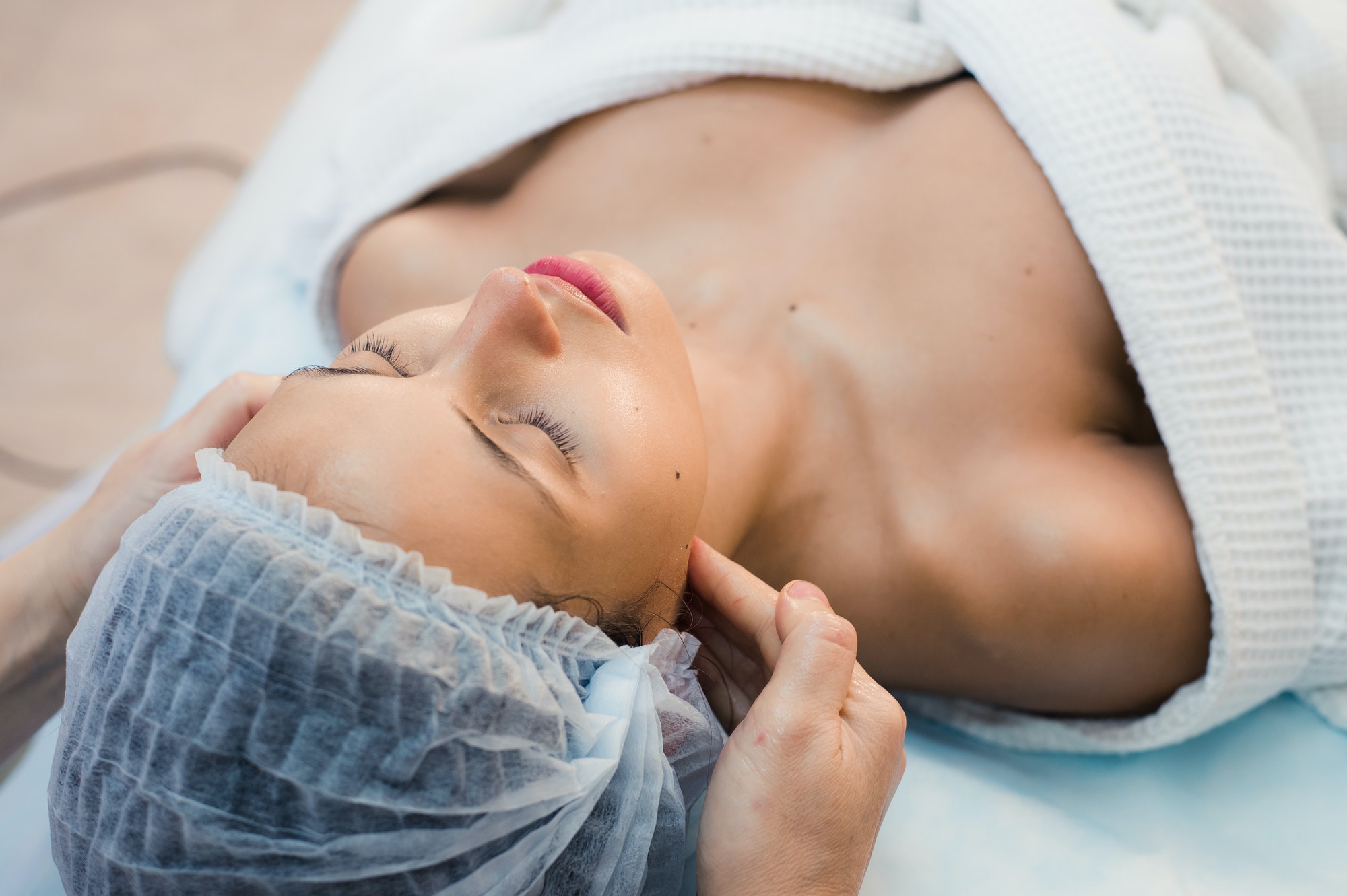young-woman-enjoying-facial-at-spa-salon.jpg